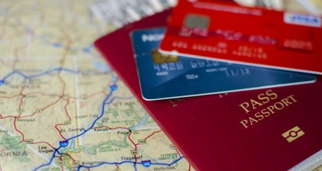 credit cards and passport sitting on map