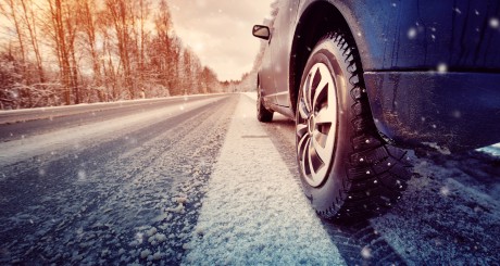 car on the road while it snows