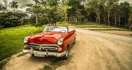 classic red car on dirt road