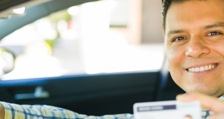hispanic man holding drivers license