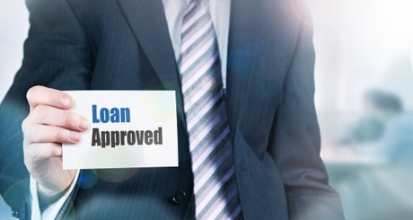 man holding loan approved sign