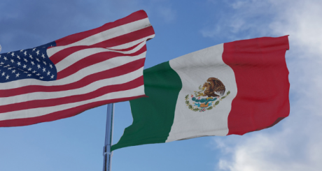 american and mexican flags in the wind