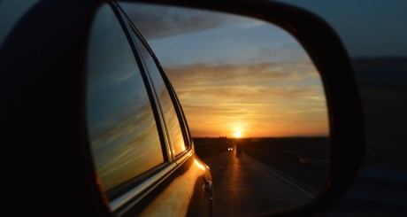 sun setting in side view mirror